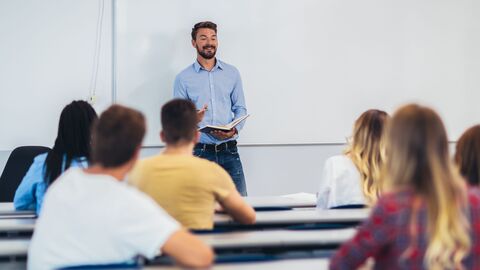 Lehrer vor eine Klasse älterer Schüler